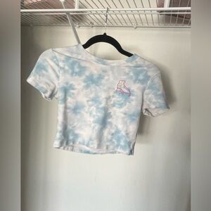 Tie die shirt with roller skates in the corner